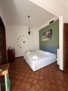 a bedroom with a bed and a clock on the wall at nonnacampagna in Bari