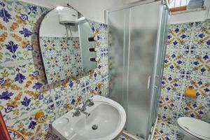 a bathroom with a sink and a shower at House La Pennata - sea view in Malfa