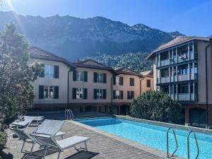 a hotel with a swimming pool with mountains in the background at Double Room by Interlaken. Parking in Därligen +38 photos