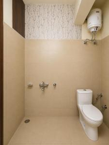 a bathroom with a toilet and a sink at Cross Hill House Mussoorie in Mussoorie +23 photos
