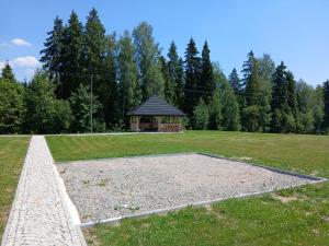 a park with a gazebo in the middle of a field at Olesiówka in Nowy Targ