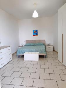 a bedroom with a bed and a table in it at Appartamenti Villa Verde in Caprioli