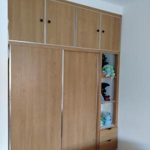 a large wooden cabinet with doors and shelves at Location Kelibia in Kelibia