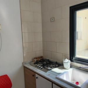 a kitchen with a stove and a sink at Location Kelibia in Kelibia