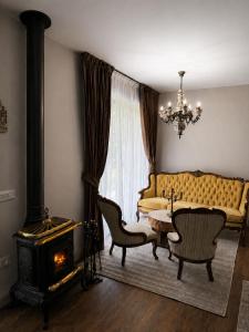 a living room with a couch and a table and a fireplace at Cabana Forest in Borşa