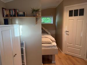 a small room with a bed and a closet at Stuga Marstrand in Marstrand