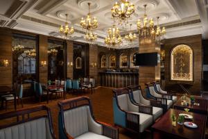 a restaurant with chairs and tables and chandeliers at Blueworld Castles in Kānpur