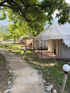 a large tent in a field next to a road at starry nights stay in Batakūt