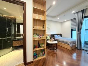 a bedroom with a bed and a bathroom with a shower at Mai home in Hai Phong