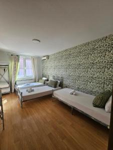 a living room with two beds and a couch at Family Hotel Amor in Ruse
