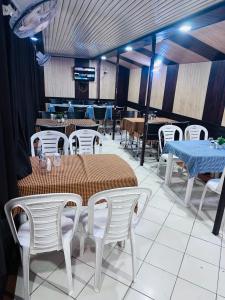 a dining room with tables and white chairs and a table and chairsktop at Hotel Sheela, 100m from Taj Mahal in Agra +36 photos