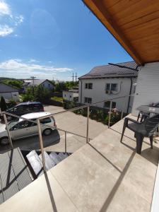 a balcony of a house with a car parked on it at Agape Speranta 96 in Piteşti