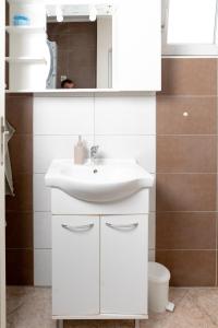 a bathroom with a white sink and a mirror at Apartman "JOKA" in Đakovo +57 photos