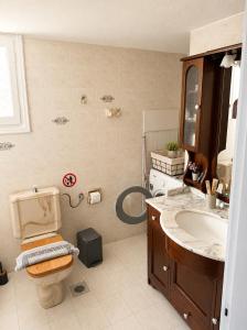 a bathroom with a toilet and a sink at Mamas House Spetses in Spetses +7 photos