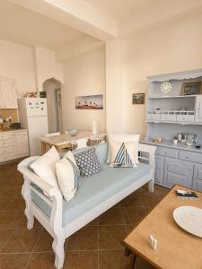 a living room with a couch and a kitchen at Mamas House Spetses in Spetses