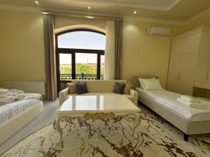a living room with a couch and a table at Jahanshah GuestHouse in Samarkand