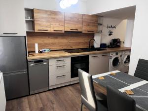 a kitchen with a table and a stove top oven at RUX Central Park in Petroşani