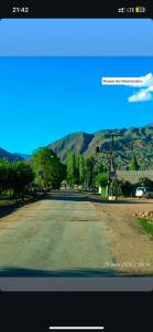 an empty street with a mountain in the background at Aina guesthouse in Kyzyloy