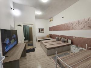 a living room with a couch and a flat screen tv at Agape Speranta 96 in Piteşti