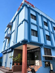 a blue building with a sign on it at Hotel Balaji Inn in Raipur