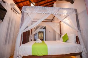 a bedroom with a bed with a canopy at KapuGedara297 in Galle +109 photos