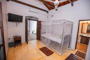 a bedroom with a bed with a mosquito net at KapuGedara297 in Galle