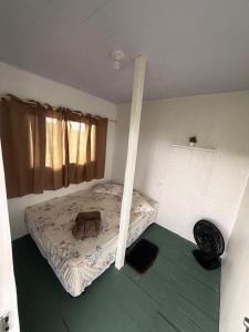 a room with a bed with a bag on it at Casa sol in Bragança +7 photos