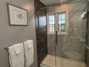 a bathroom with a shower and a glass shower stall at Three Pines Private Bedroom Suite in Moncton