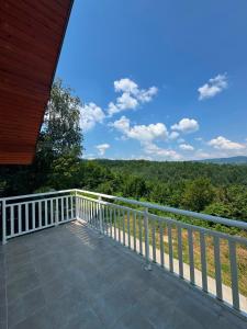 a balcony of a house with a view of the woods at Sky view villa in Obrovac