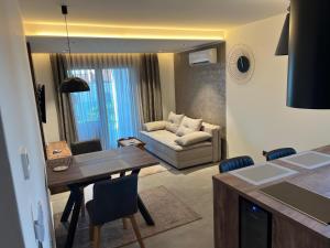a living room with a table and a couch at Residence 4U in Malinska