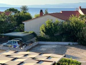 a house with a car parked in a driveway at Residence 4U in Malinska