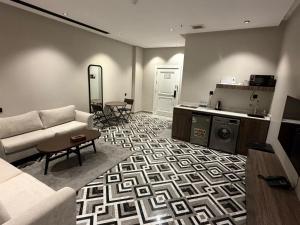 a living room with a couch and a table at شقق ثري ستار للشقق المخدومة 5 in Al Kharj