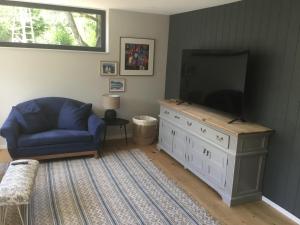 a living room with a blue couch and a flat screen tv at Stunning New Apartment Senningerberg in Niederanven