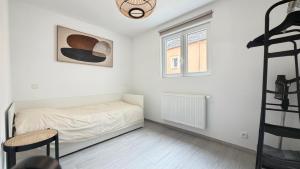 a small bedroom with a bed and a ladder at L'Annexe in Arlon