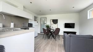 a kitchen and living room with a table and chairs at L'Annexe in Arlon +6 photos