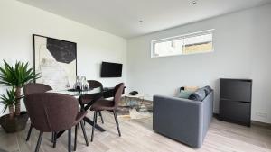 a living room with a table and chairs and a couch at L'Annexe in Arlon