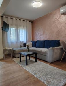 a living room with a couch and a table at Vikendica Vidik in Divčibare