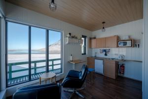 a kitchen with a view of the ocean from a room at Grásteinn, guesthouse 2 in Grundarfjordur