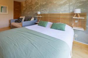 a bedroom with a large bed and a couch at Auberge du Fel in Le Fel