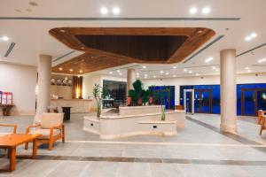 a lobby of a hotel with tables and chairs at UTOPIA Blue Resort in Quseir +242 photos