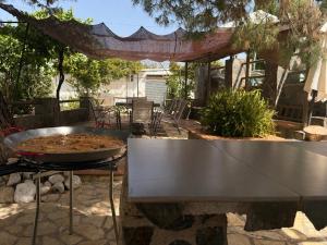 a grill with a pan of food on a table at Villa 365 in La Rábita