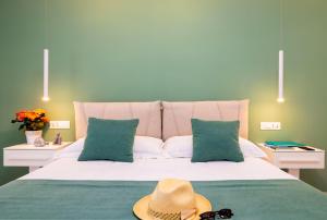 a bedroom with a bed with a hat on it at Le Stagioni Rooms in Vieste