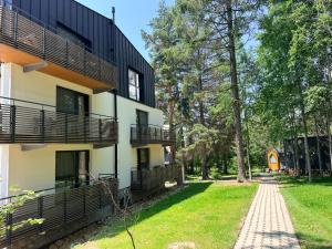 a house with balconies on the side of it at Apartmán Forest, Tatranská Štrba in Tatranska Strba