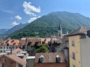 a view of a town with a church and a mountain at Hotel Alpenstadt in Chur