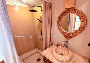 a bathroom with a wooden sink and a mirror at Amazing Luxury Camp in Merzouga +45 photos