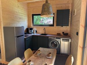 a small kitchen with a table and a refrigerator at Stodoła in Kamień +11 photos