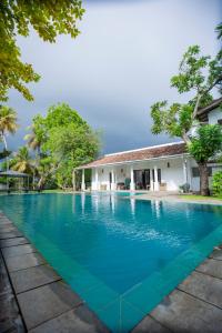 a swimming pool in front of a house at KapuGedara297 in Galle