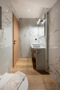 a bathroom with a sink and a toilet at SoleLuna - The Villas Project in Marmaroto