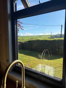 a window with a view of a green field at Valentine in Longdown