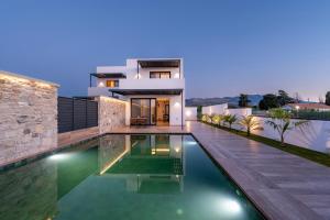 a house with a swimming pool in front of it at SoleLuna - The Villas Project in Marmaroto